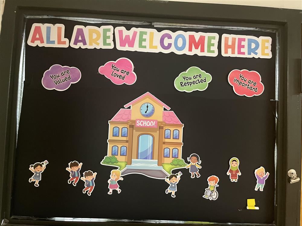  school house with words all are welcome here